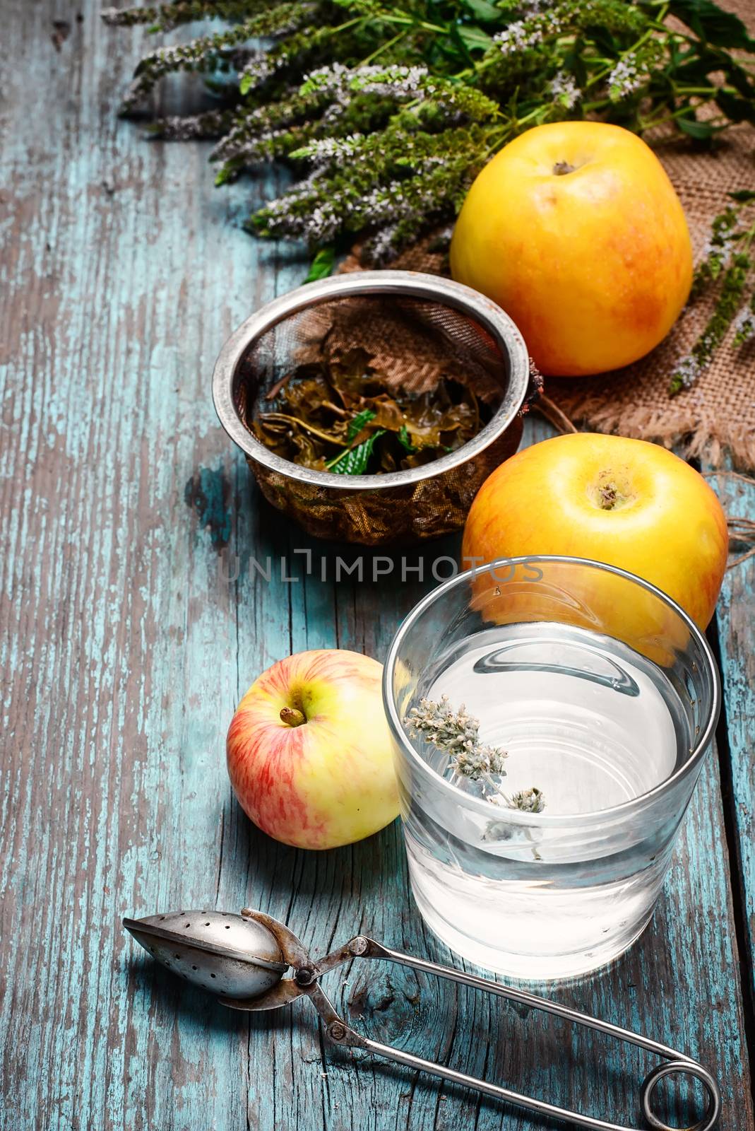 Plucked fresh bunch of fragrant mint,tea brew and apples