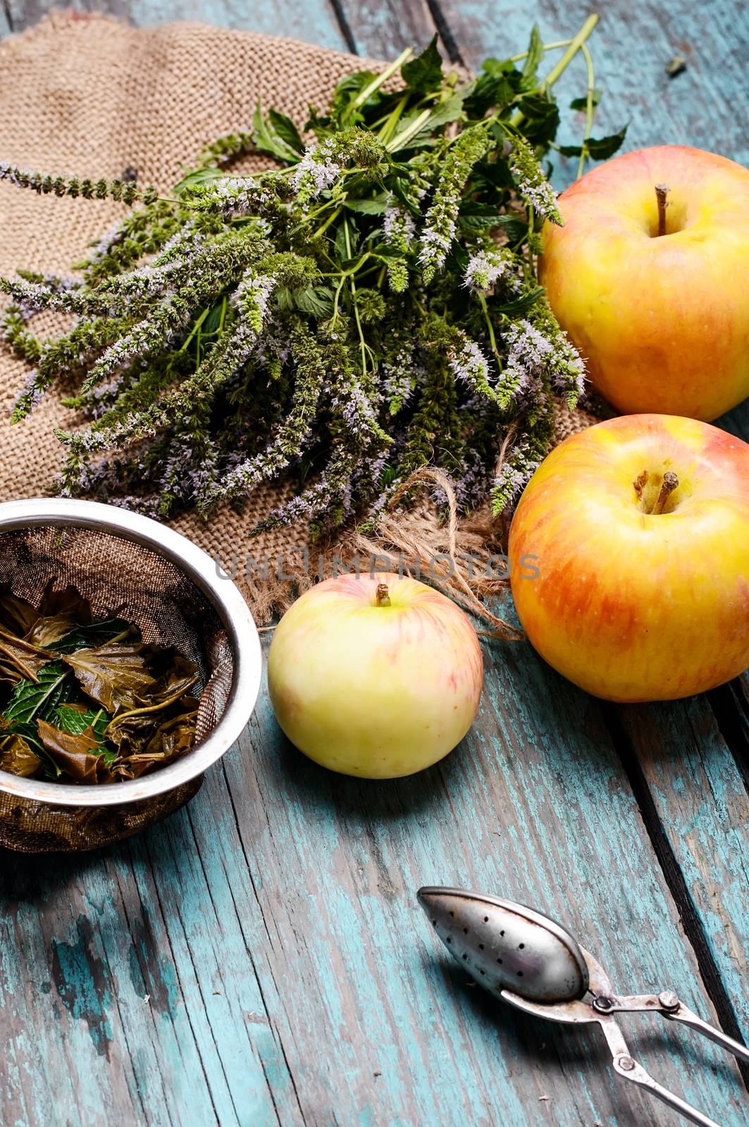 Plucked fresh bunch of fragrant mint,tea brew and apples