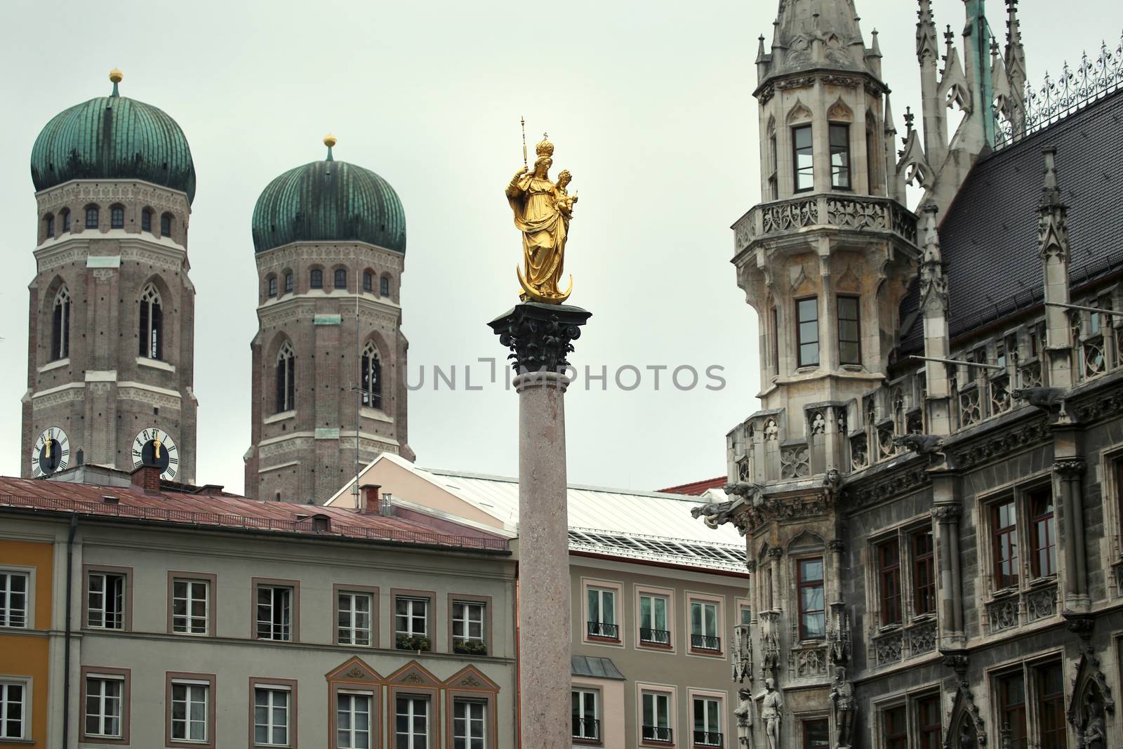 The Golden statue of Mary (Mariensaule), a Marian column on the Marienplatz, Frauenkirche in the background in Munich, German
