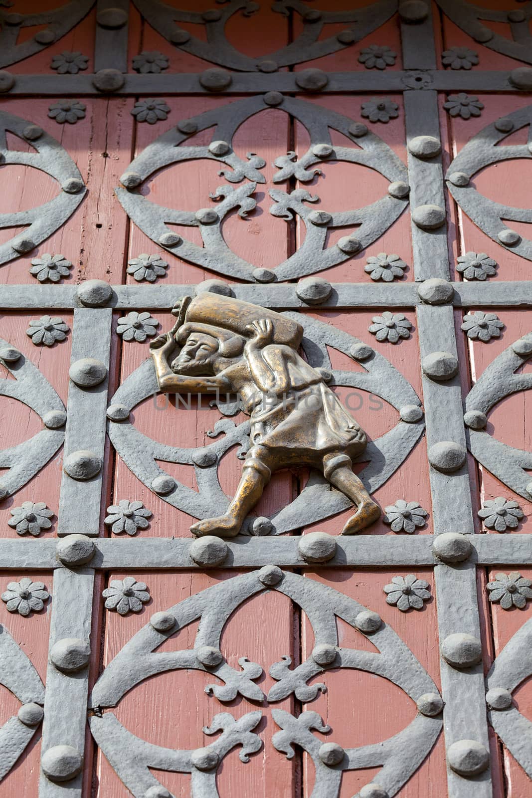 Porter  on the doors of the main entrance to Catalan Gothic church Santa Maria del Mar, Barcelona, Spain