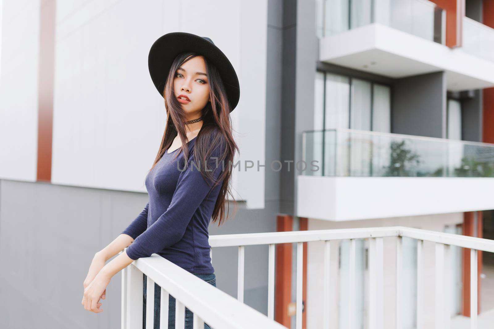 Beautiful asian young woman smiling on the city by nopparats