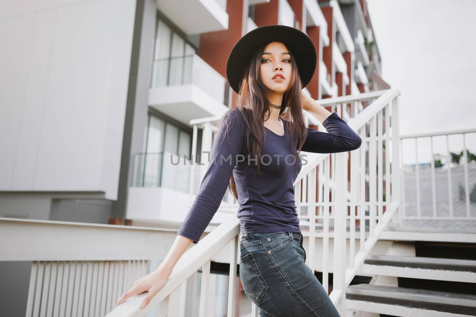Beautiful asian young woman smiling on the city by nopparats