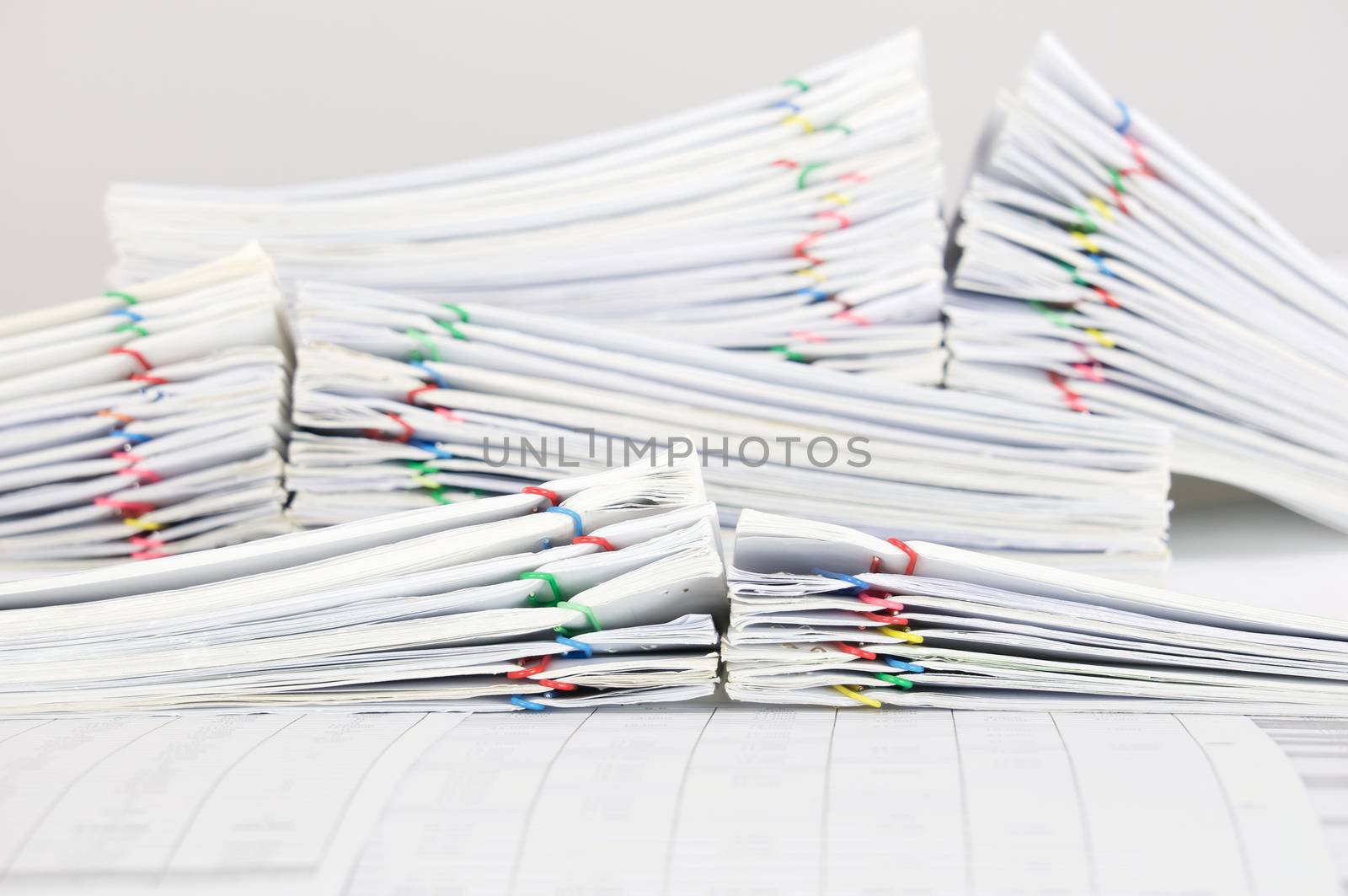 Pile overload report with colorful paperclip place on finance account by eaglesky