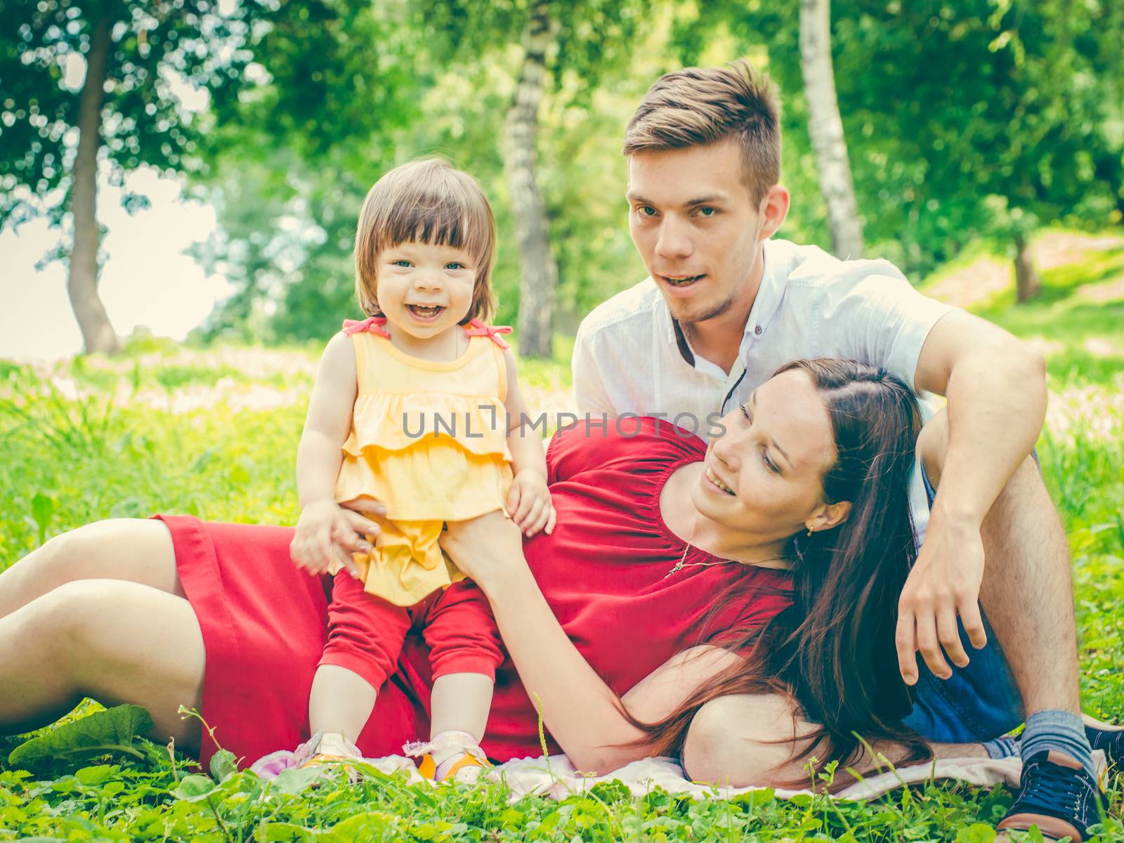 Close up family portraitoutdoors. Family with little baby having fun in summer