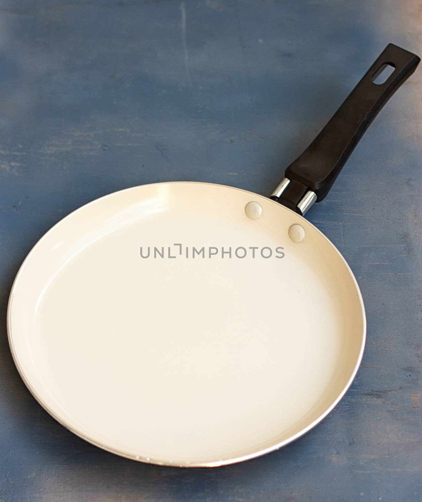 Pan bottom with white on a wooden blue background