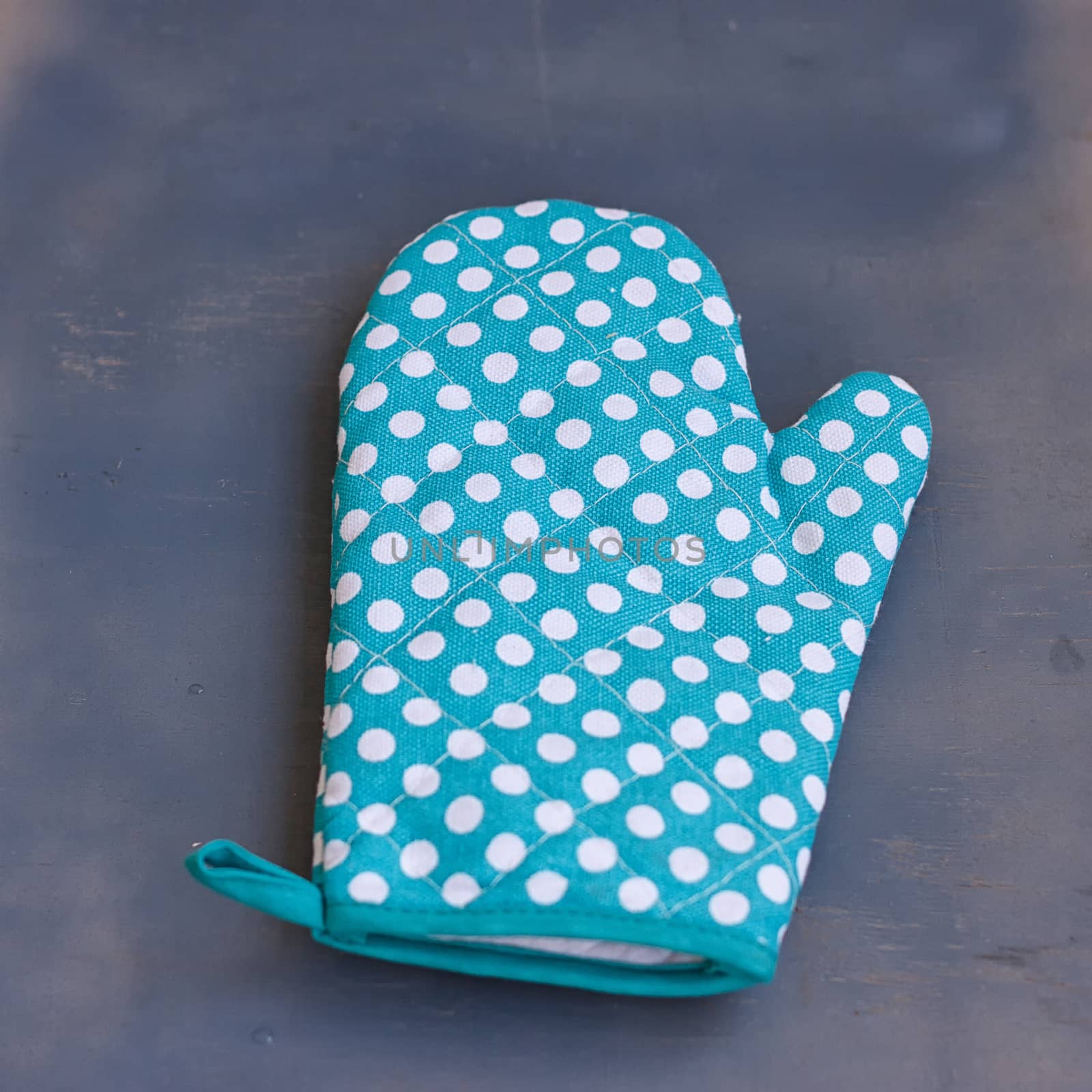 Oven mitt -glove or potholder on the wooden background. by victosha