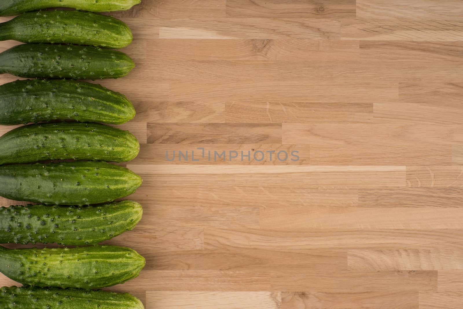 Cucumbers on a wooden background. by DGolbay