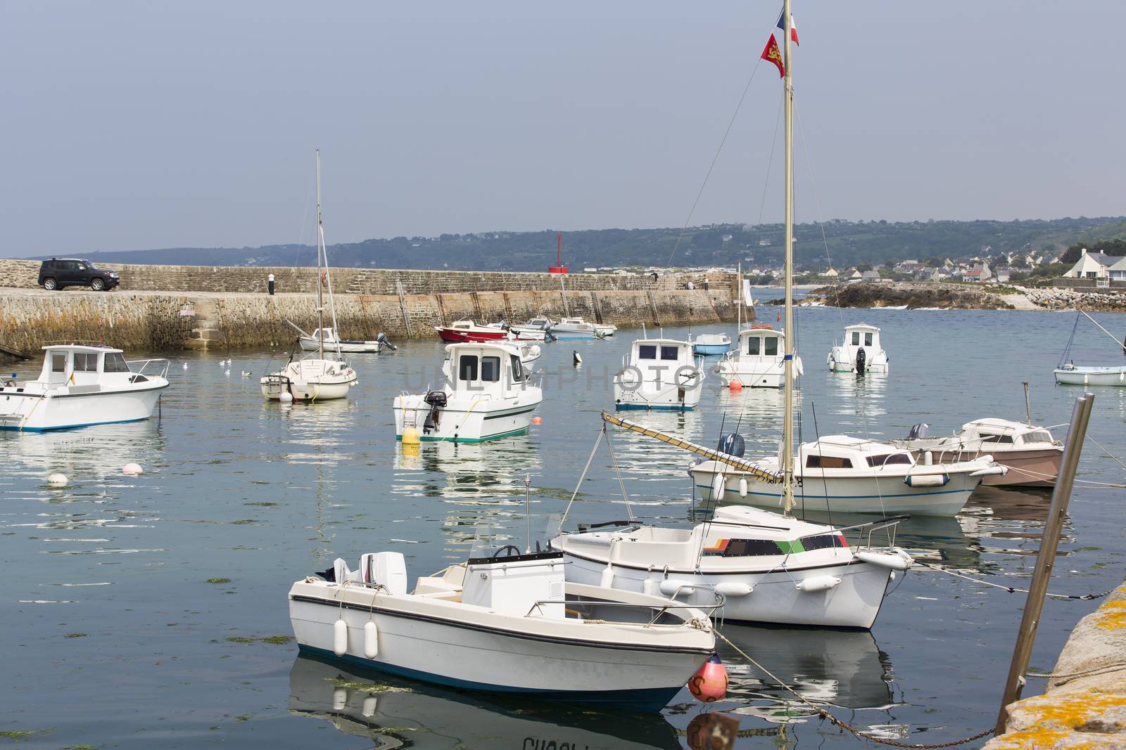 Small fishing boats waiting in port France water reflection