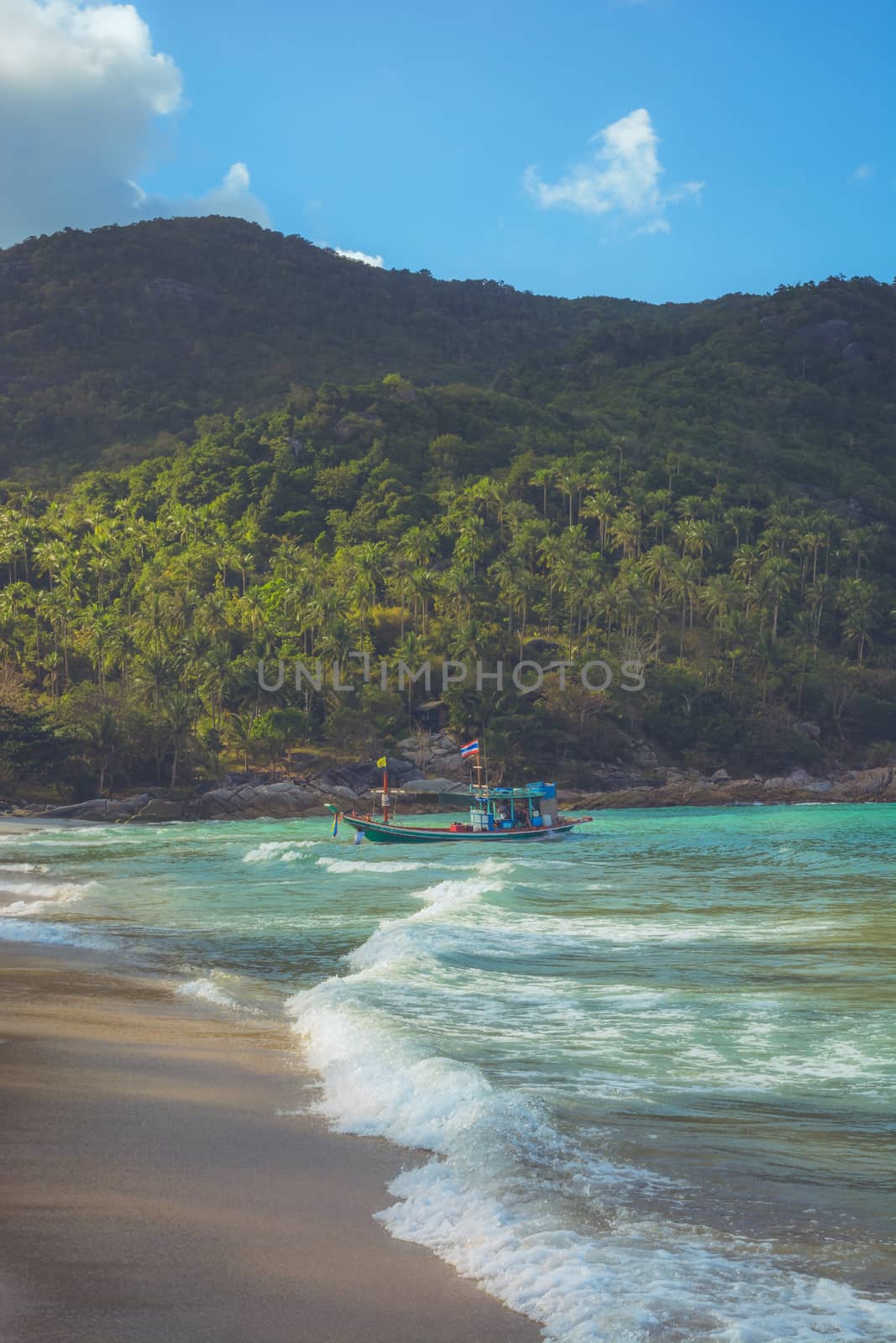 A boat is anchored at Bottle Beach, Koh Pha Ngan, Thailand