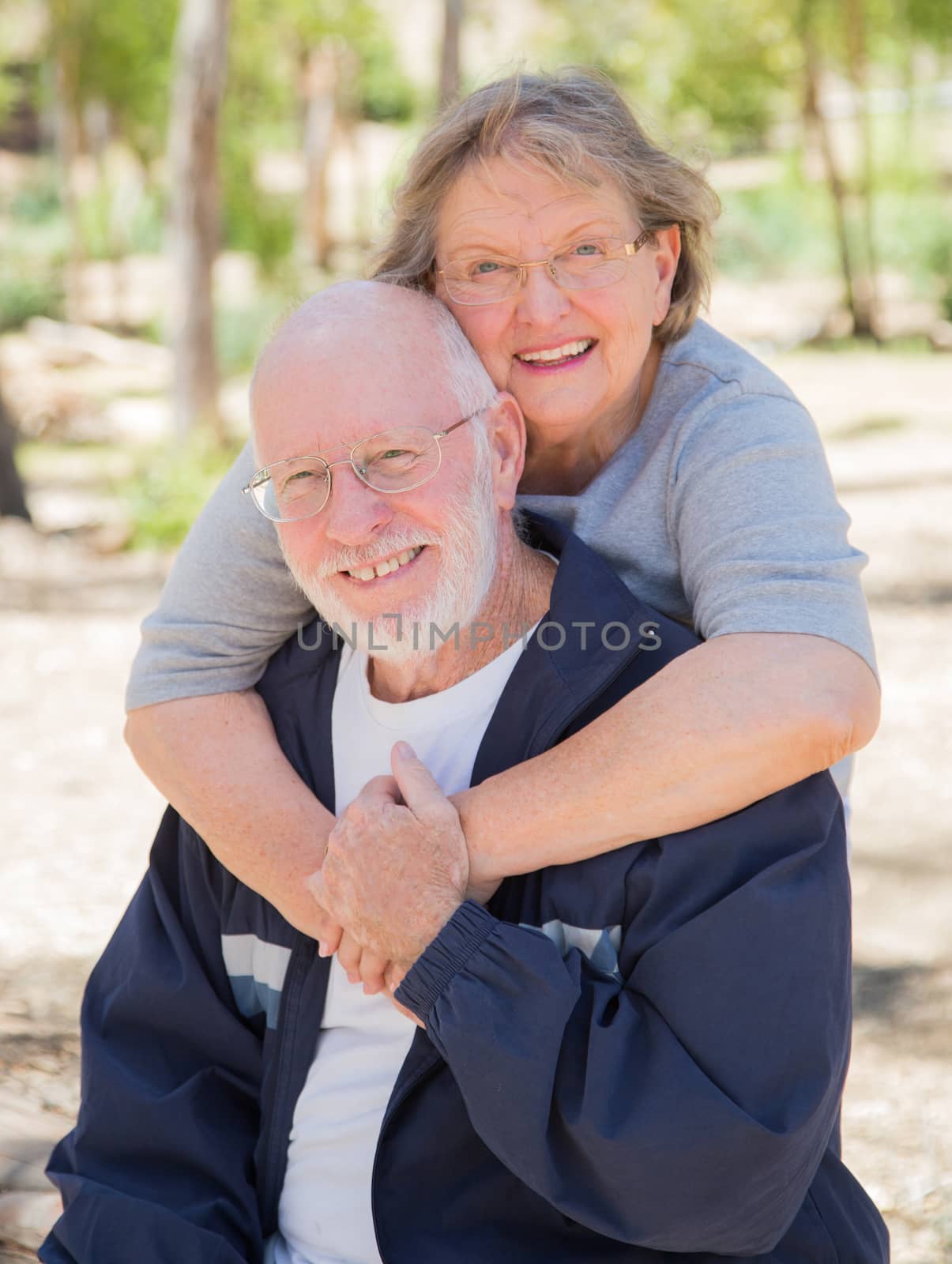 Happy Senior Couple Portrait Outdoors At Park.