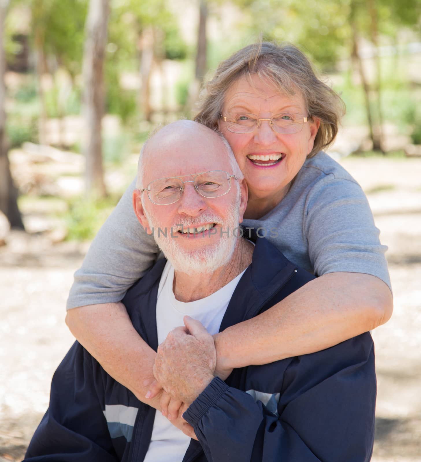Happy Senior Couple Portrait Outdoors At Park.