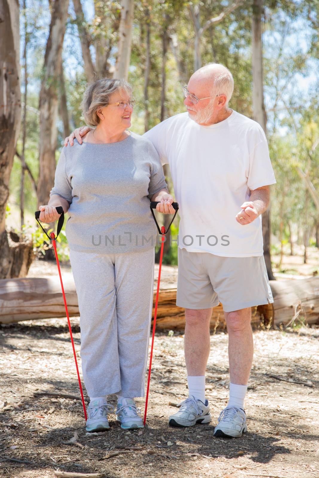 Happy Healthy Senior Couple Exercising Outside Together.