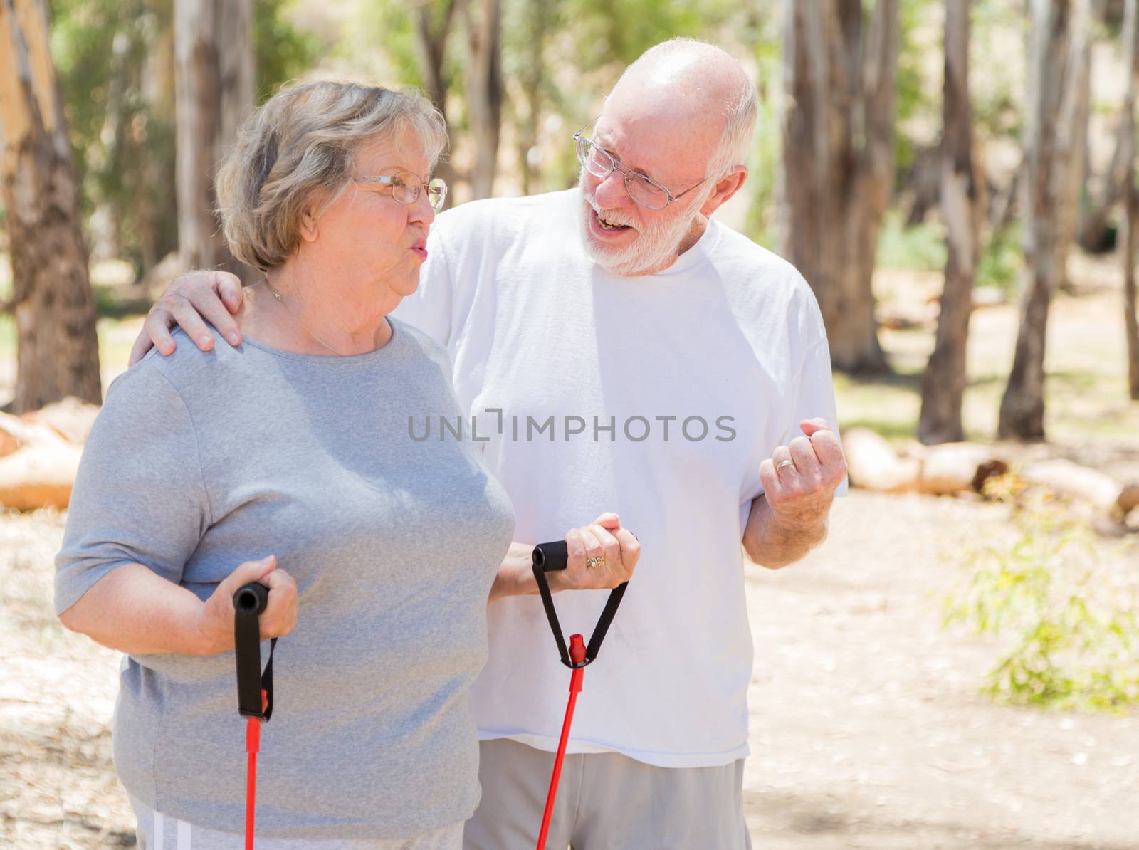 Happy Healthy Senior Couple Exercising Outside Together.