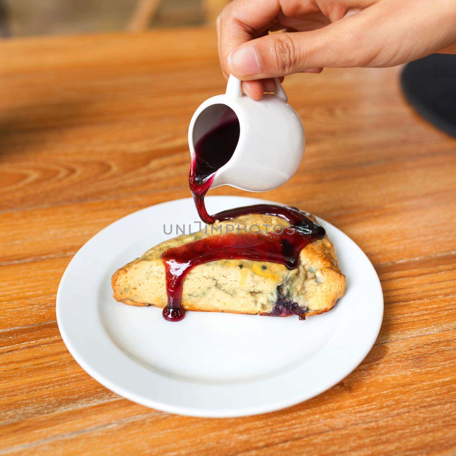 Tasty pie with raspberry jam on wood table by nopparats