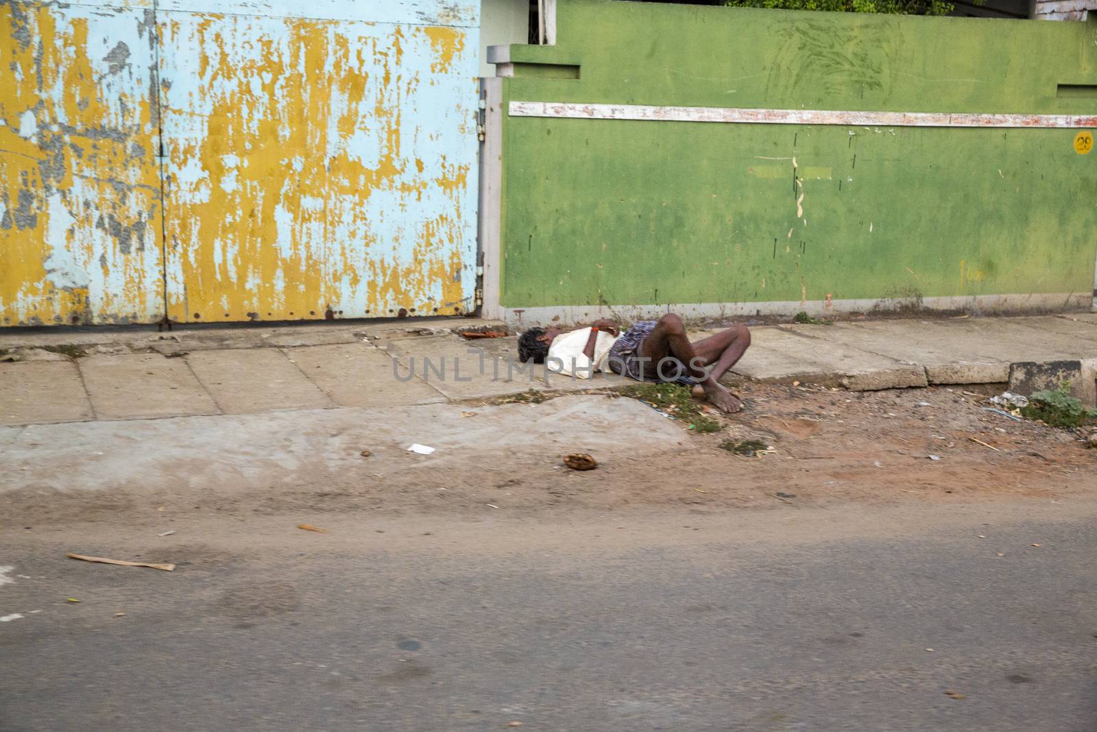beggar, homeless sleeping in the street, India, Tamil Nadu