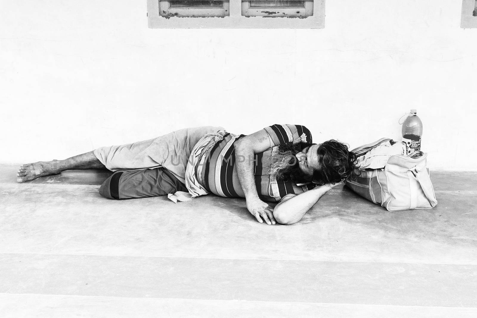 homeless man sleeping India by CatherineL-Prod