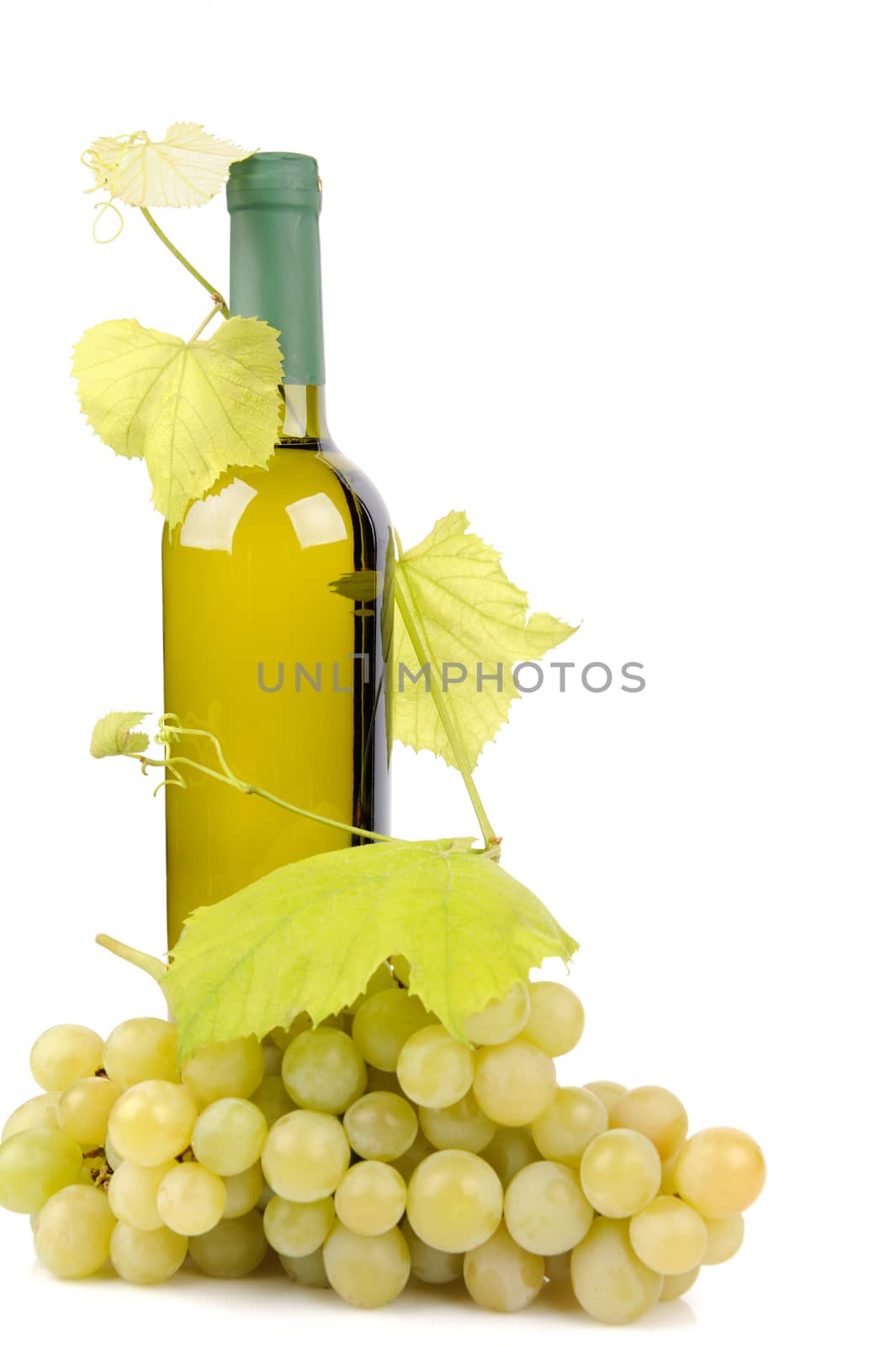 White wine bottle and grapes isolated on white background