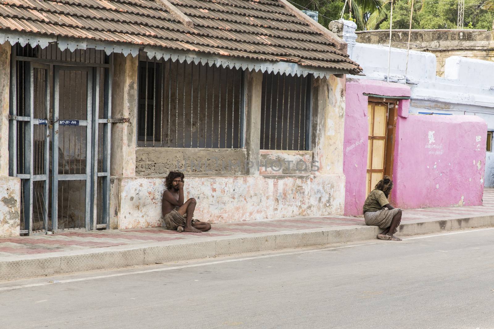 Documentary editorial image. Pondicherry, Tamil Nadu, India - June 24 2014. homeless and poor people writing, sleeping, walking in the street