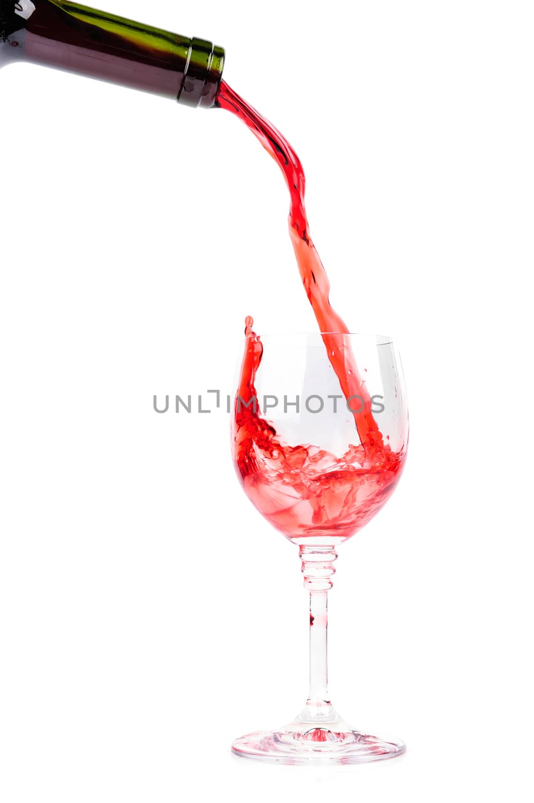 Red wine pouring into wine glass by byrdyak