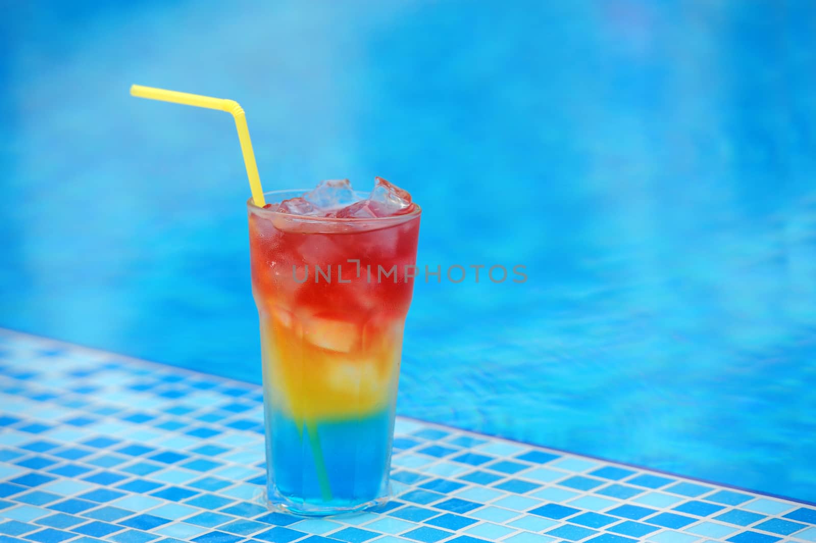 Colourful cocktail on the background of the swimming pool