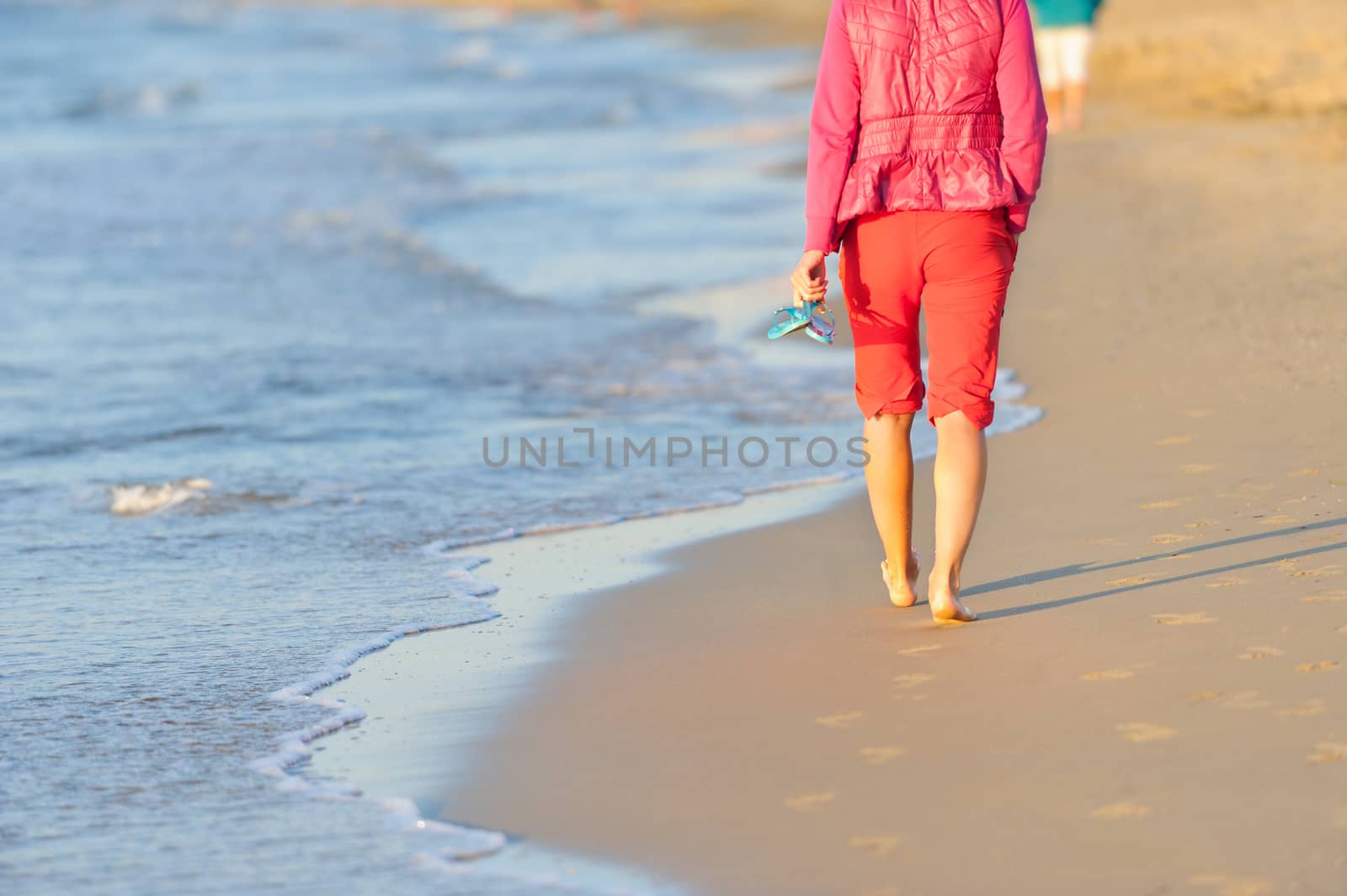 Walking on the beach in sunset time