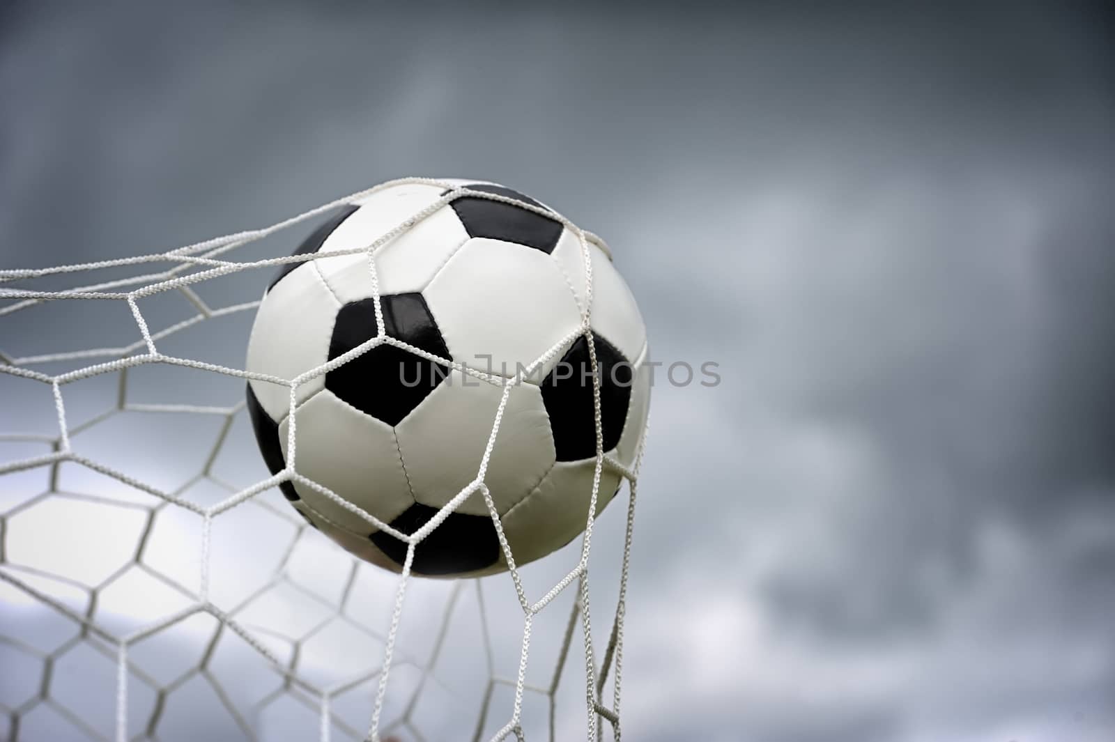 Football. The ball flies into the net gate