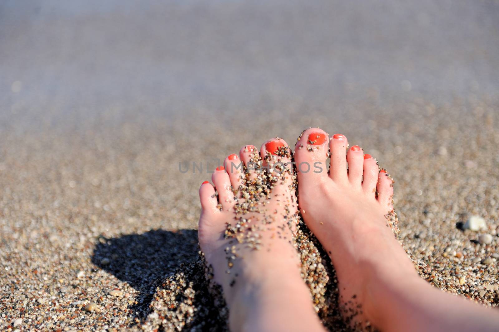 Vacation holidays. Woman feet closeup of girl relaxing on beach