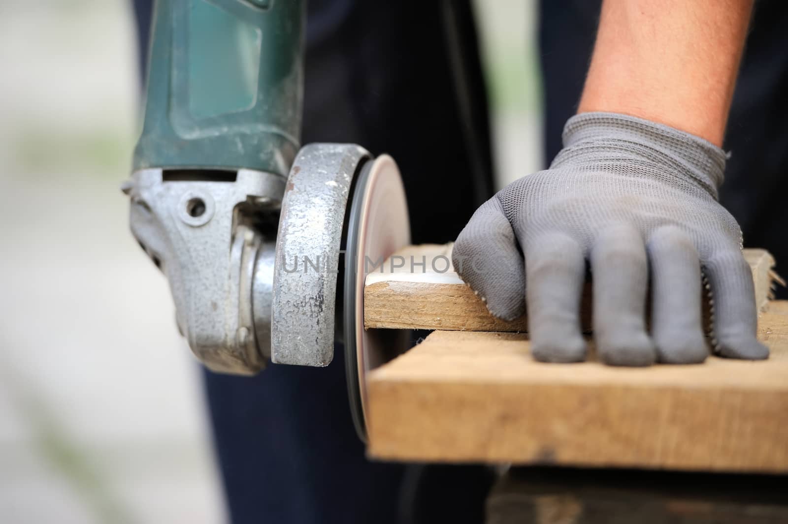 Worker polishing a wood table. Close-up