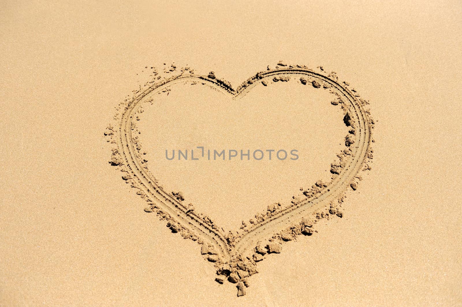 A heart shape drawn in the sand