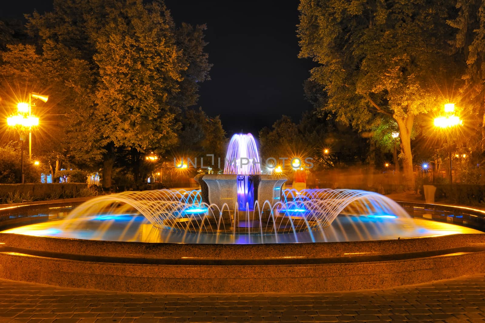 Colored water fountain at night