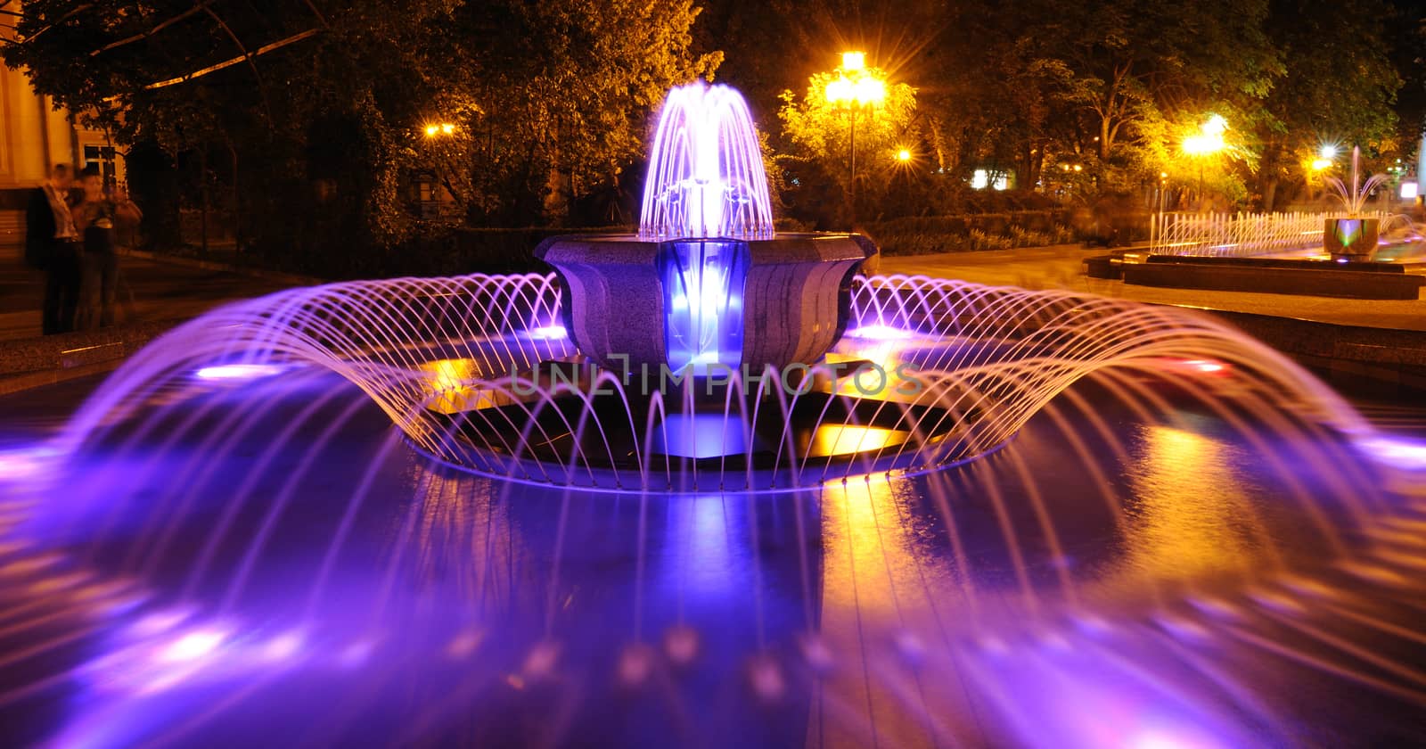 Colored water fountain at night