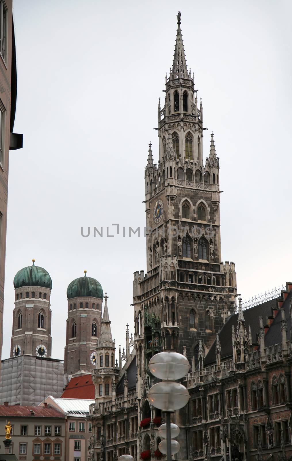 The Golden statue of Mary (Mariensaule), a Marian column on the Marienplatz, Frauenkirche in the background in Munich, German