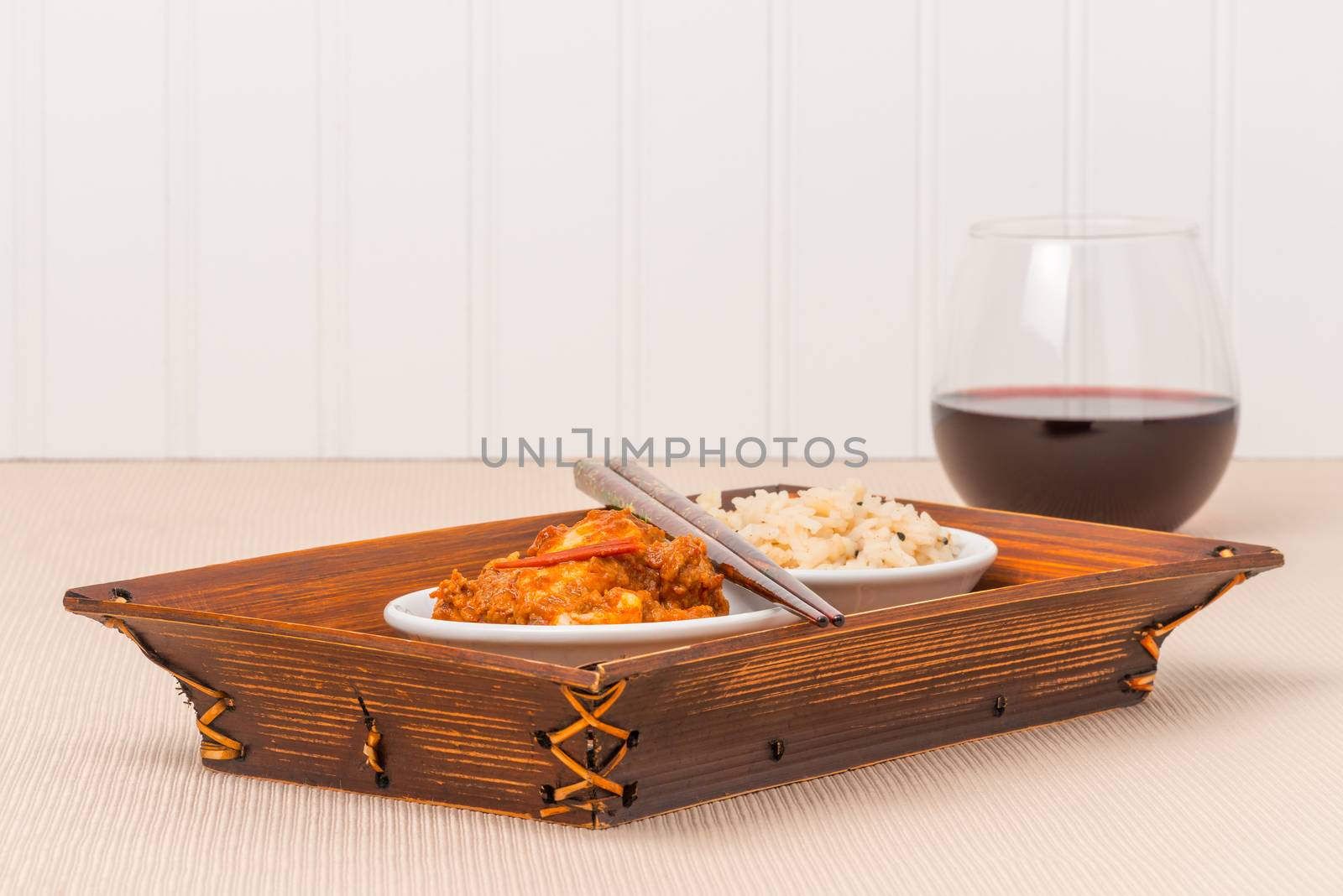 Oriental spicy chicken and rice in a bamboo server.