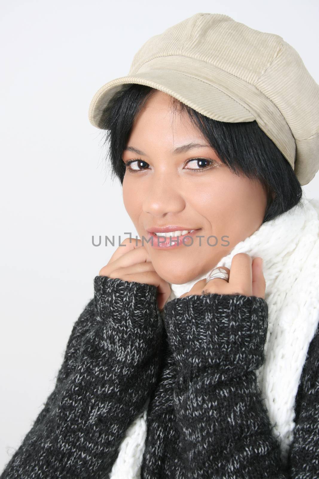 Young brunette female wearing a hat with scarf wrapped around her 