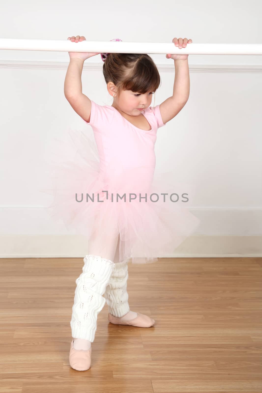 Little ballet girl dancing in the dance studio