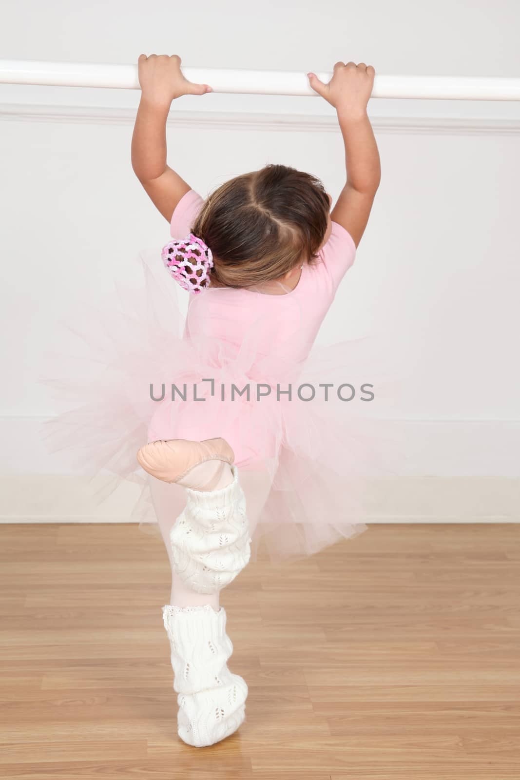 Little ballet girl dancing in the dance studio