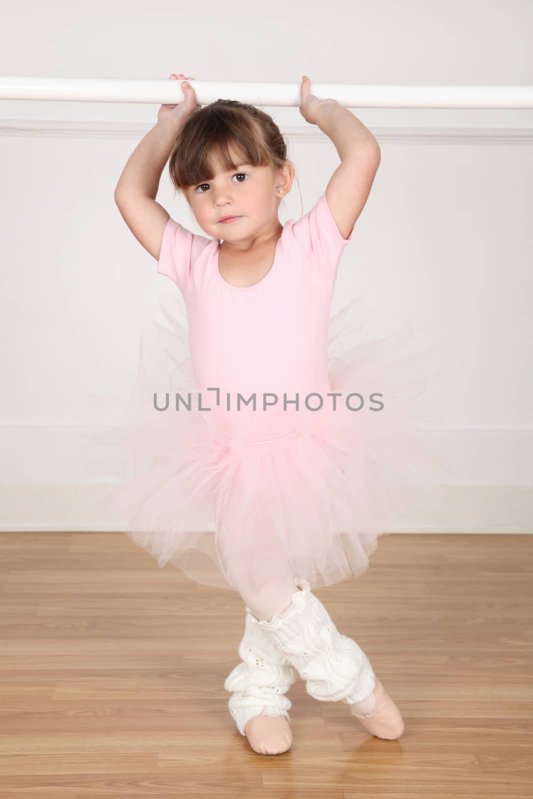 Little ballet girl dancing in the dance studio