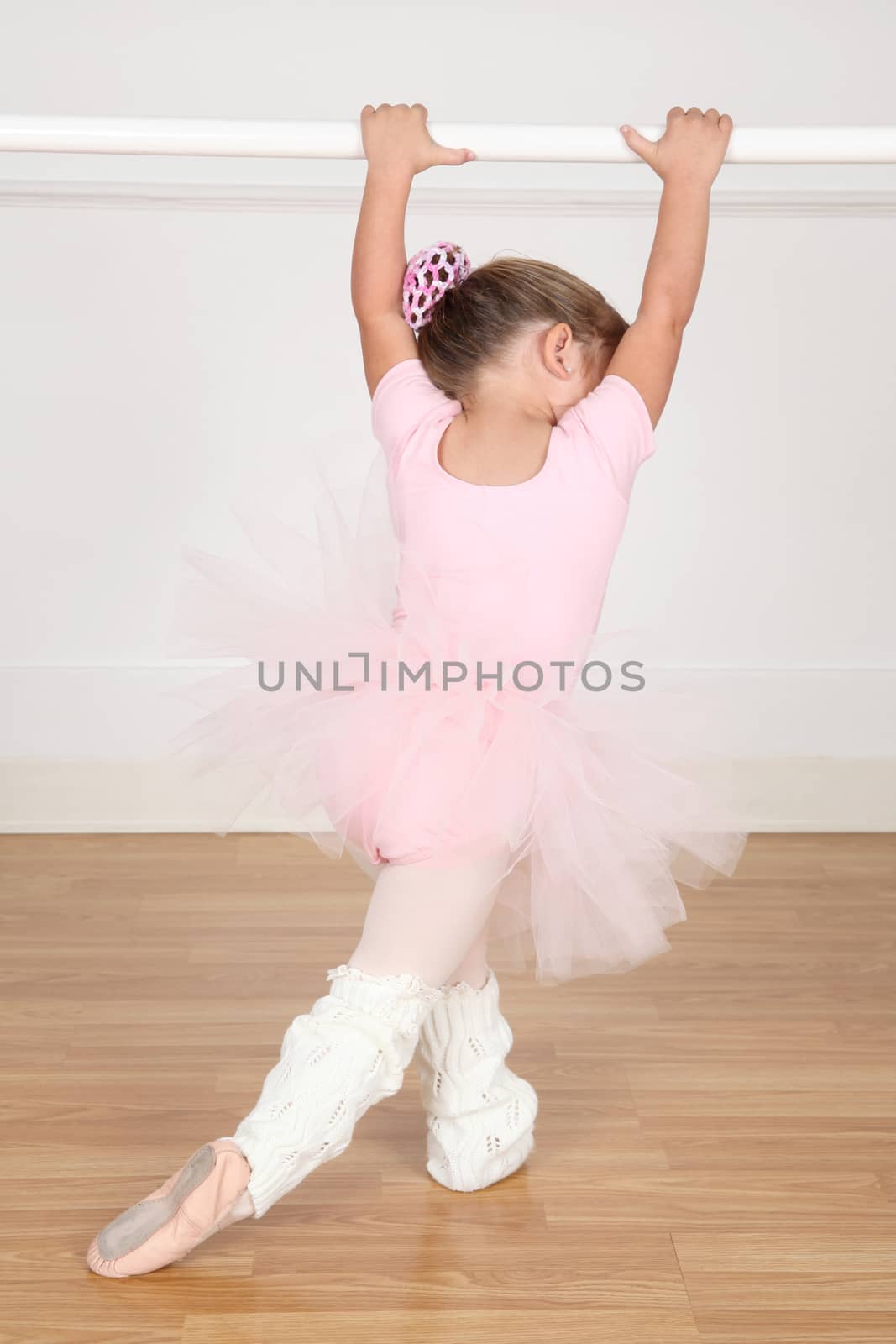 Little ballet girl dancing in the dance studio