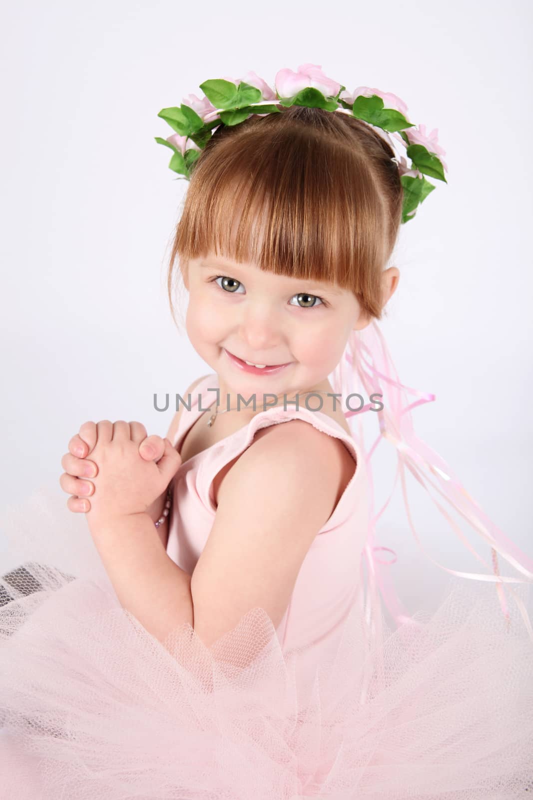 Toddler ballet girl in pink against white background