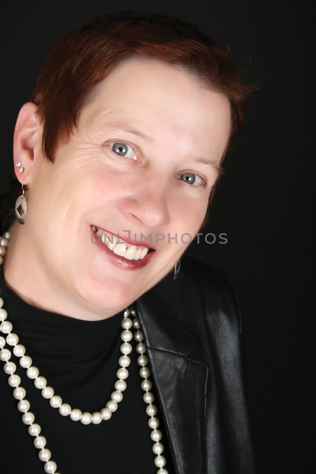 Elegant female wearing a black leather jacket and pearls