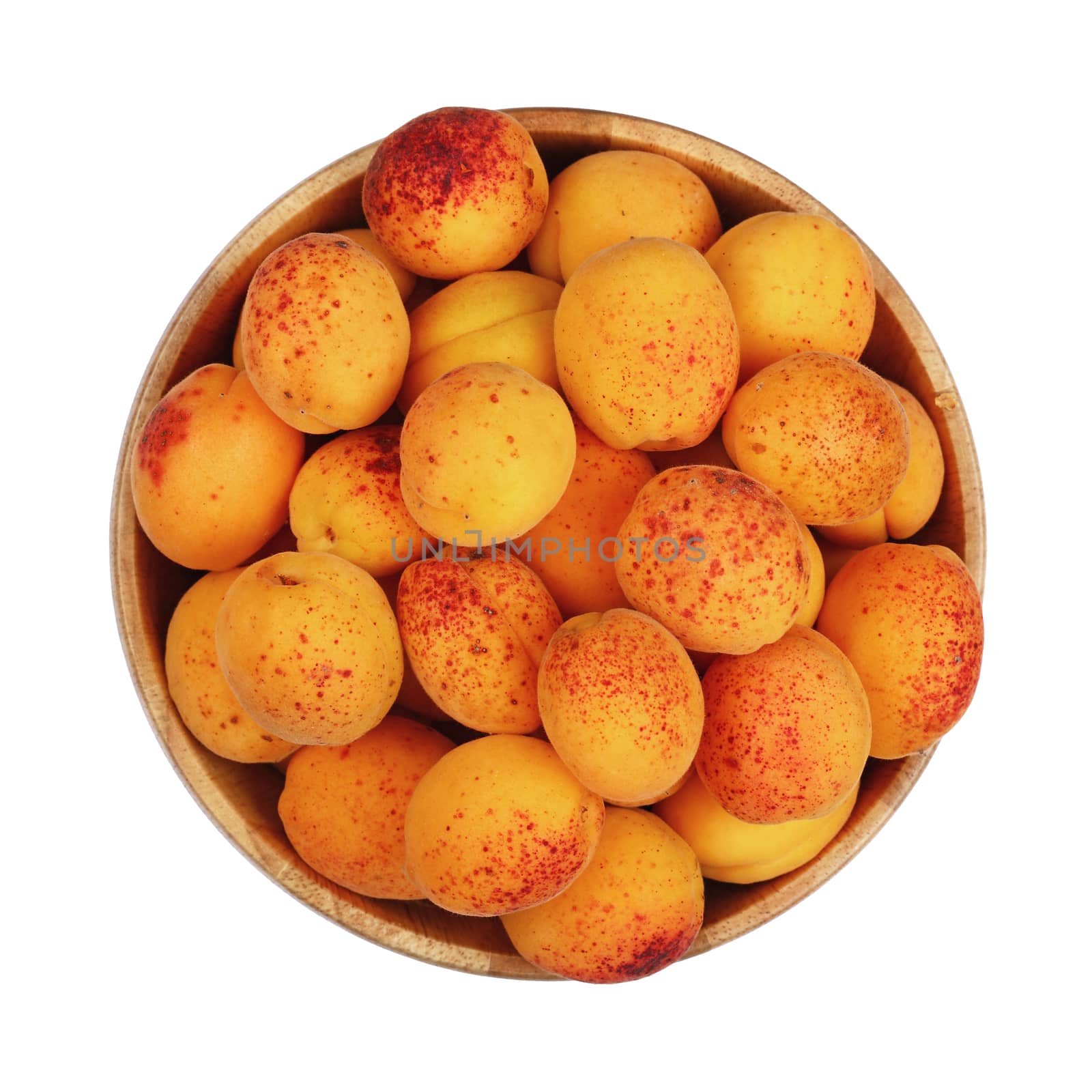 Mellow ripe fresh apricots with in big wooden bowl isolated on white background, close up, top view