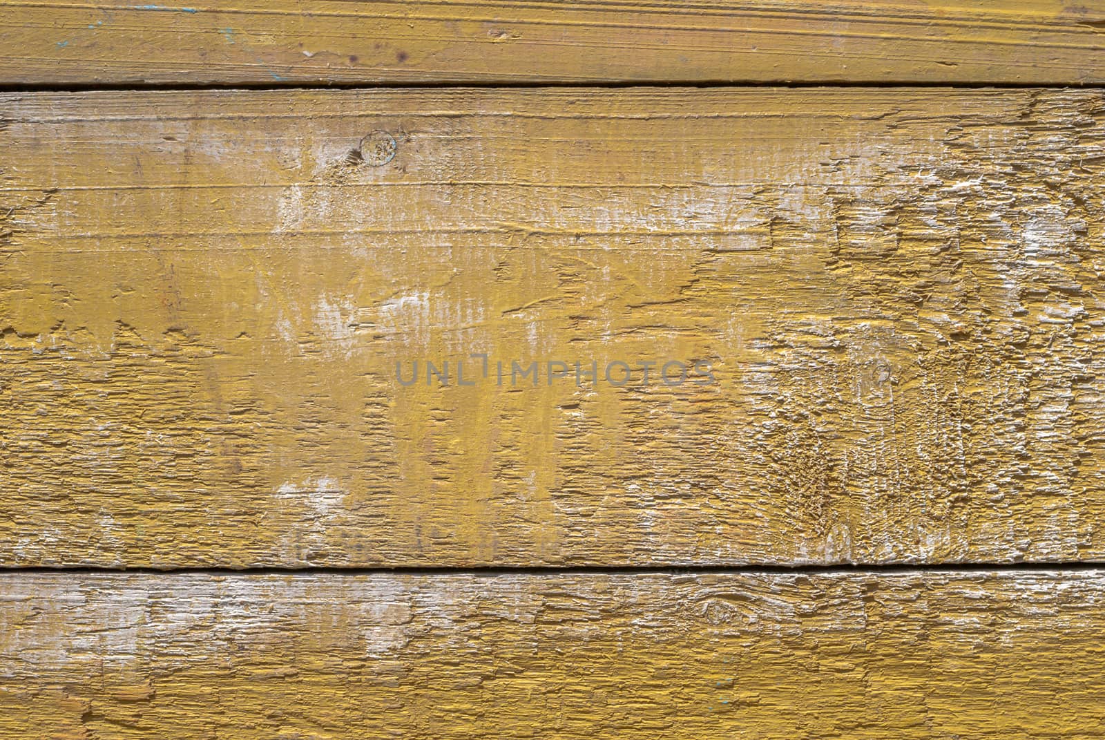 texture of wooden surface with remnants of old paint that has dried and cracked under the influence of weather