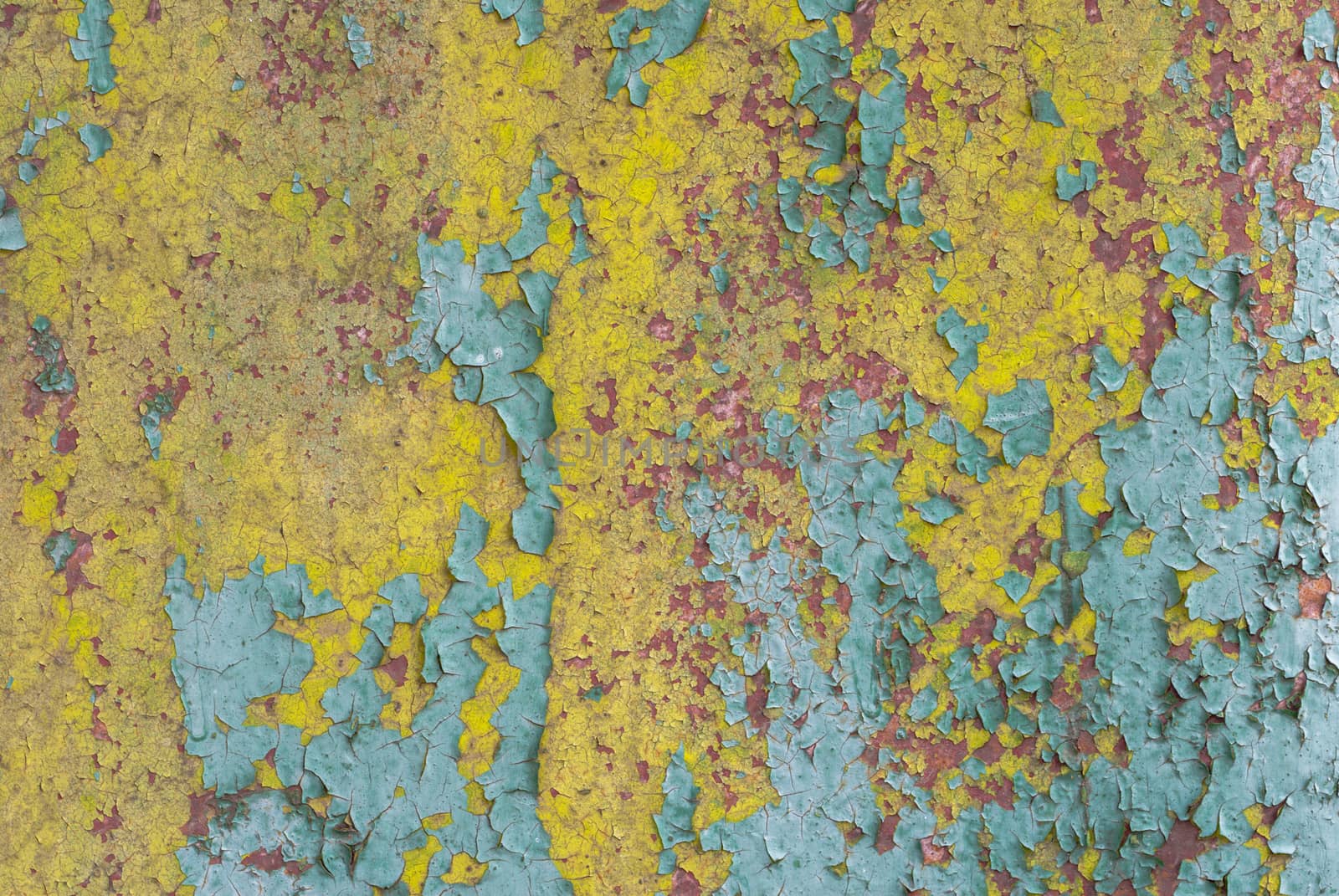 fragment of an iron surface is covered with paint, which has long been under the influence of different climatic conditions