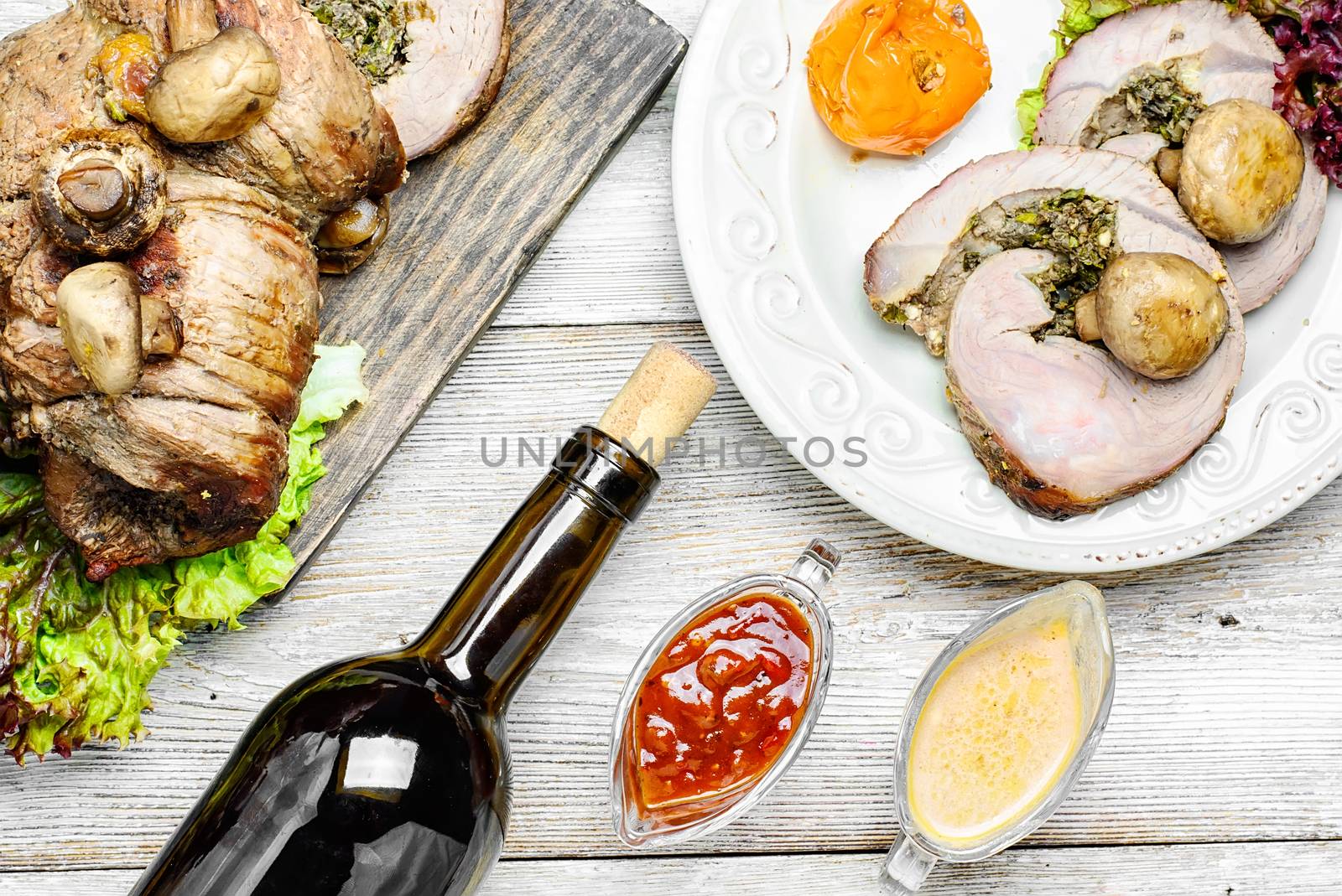 Dining table set with wine and dish of baked meat loaf