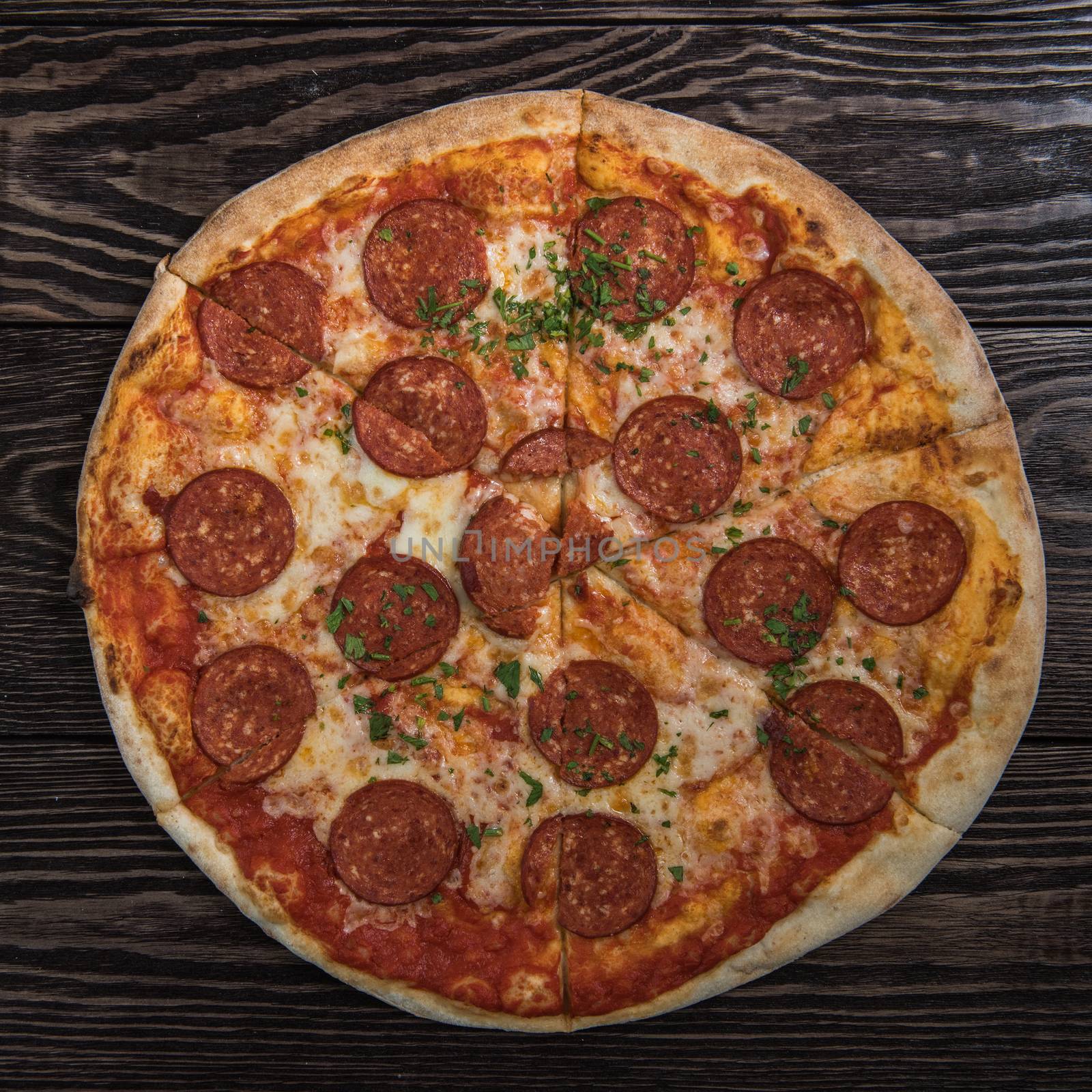 Pepperoni pizza on wooden table