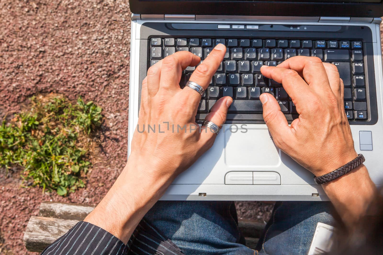 Human hands typing a laptop by andongob