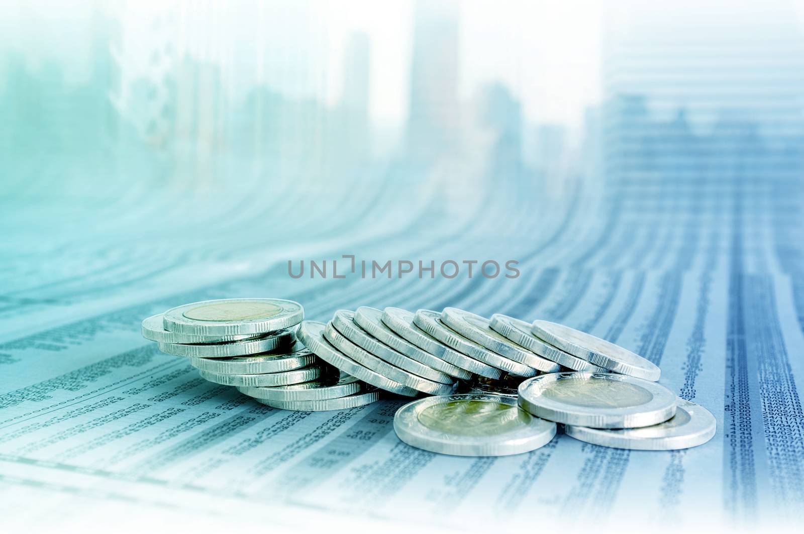 Business concept, coin stacks on news paper with cityscape background.