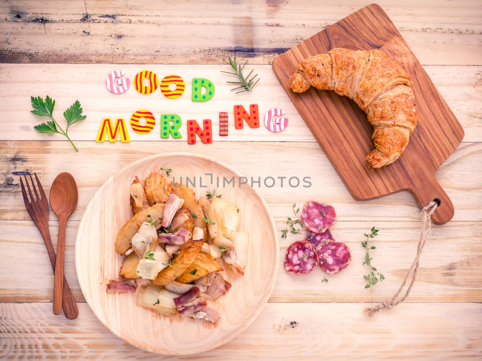 Breakfast  setup on wooden table with colourful Good Morning words.