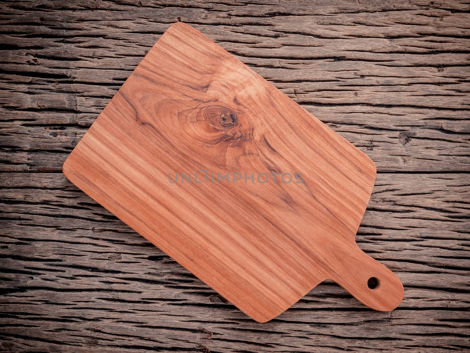 Empty vintage Teak wood cutting board on grunge wood food backgr by kerdkanno