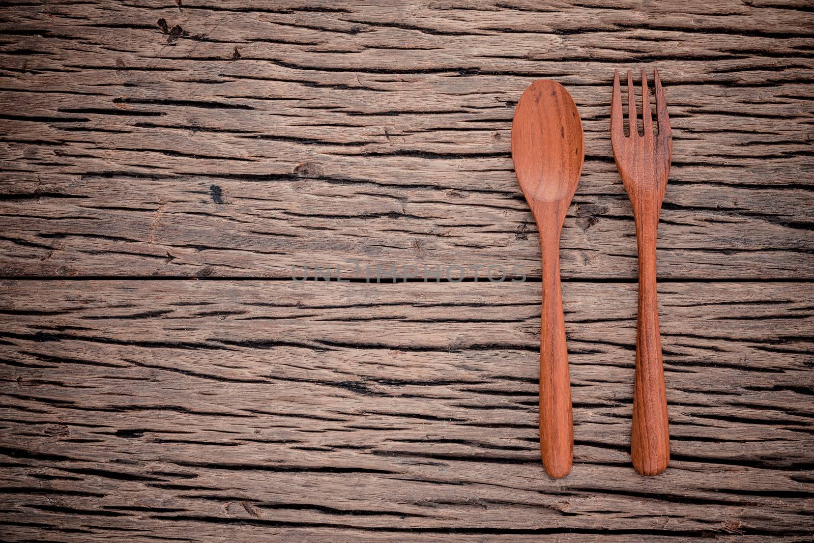 Fork and spoon on grunge wood food background concept ,menu design and advertising campaign.